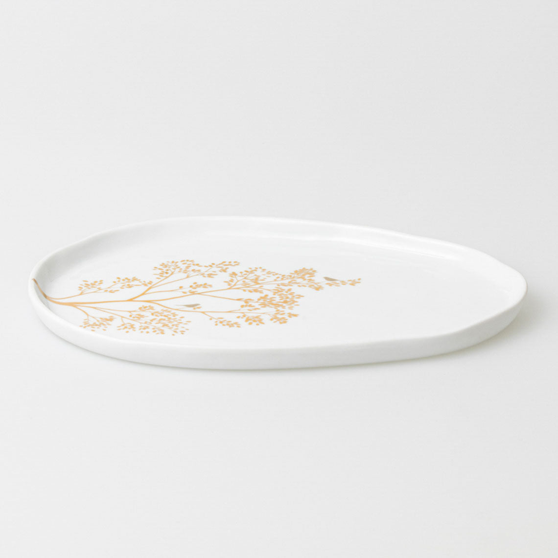 Porcelain plate with a golden branch